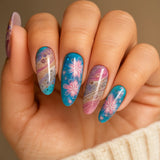 Hand with colorful floral nail art on a neutral background